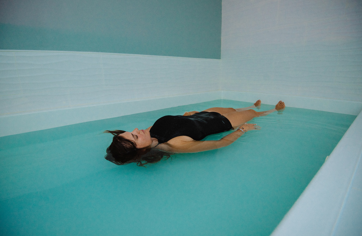 Woman relaxing and revitalizing in the Open tank float room